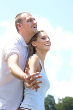 Portrait of happy couple laughing while holding by hands