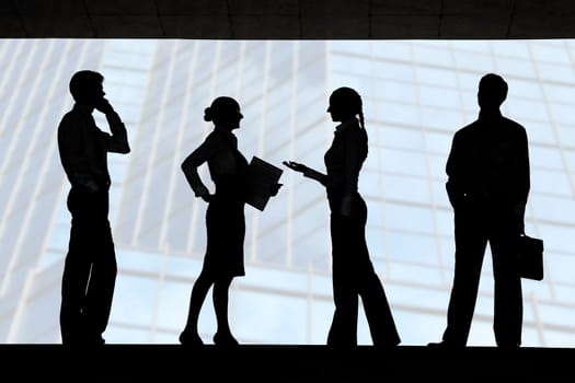 Four outlines of business partners with communicating females between two men