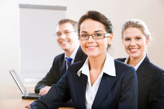 Image of female leader with her business team