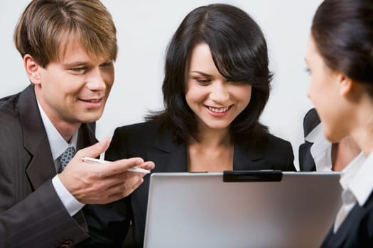 Portrait of business persons gathered together discussing an ideas