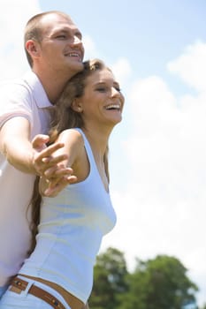 Portrait of happy couple laughing while holding by hands