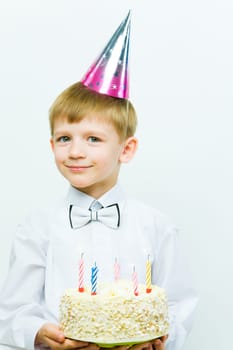 Portrait of diligent schoolboy looking at camera at his birthday