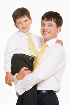 Portrait of smiling man holding his in his arms and both looking at camera over white background