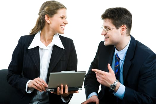 Portrait of happy specialists communicating at meeting and looking at each other with smiles