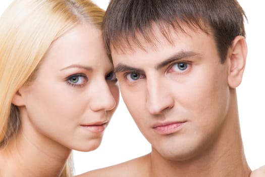 Serious man looking at camera with beautiful woman near by