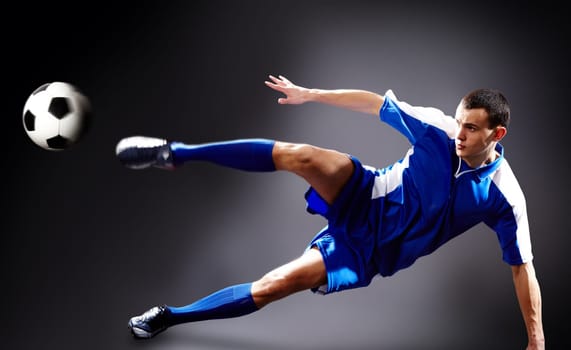 Image of soccer player doing flying kick with ball