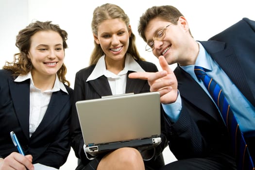 Image of successful specialists discussing a computer work