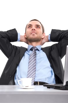 Portrait of positive man relaxing at workplace with hands behind head