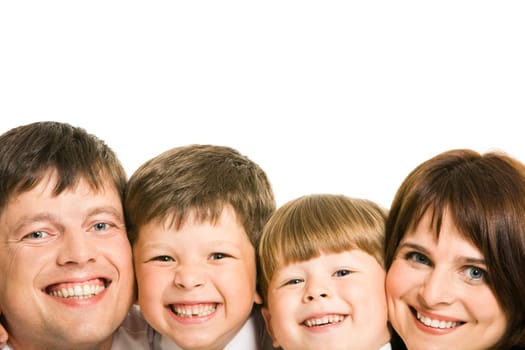 Faces of four family members laughing and looking at camera