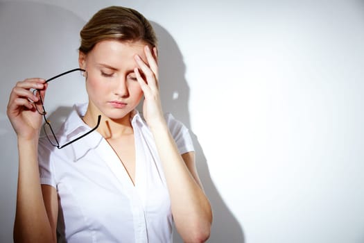 Portrait of businesswoman with strong headache