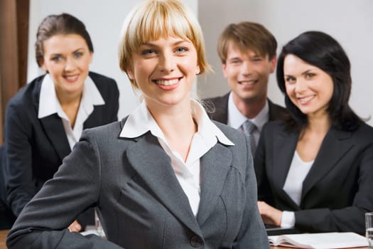 Female leader on the background of  her business team