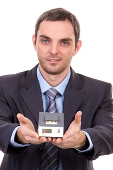 Portrait of confident male with toy house model in hands