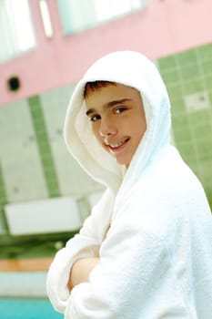 Photo of happy teenage lad in bathrobe looking at camera
