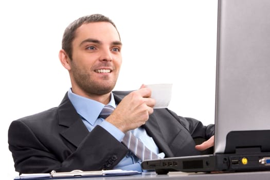 Portrait of smart businessman looking at laptop monitor with cup of coffee in hand