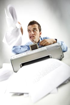 Portrait of annoyed businessman holding papers printed by scanner