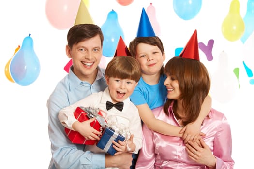 Portrait of happy boys and their parents embracing each other and laughing
