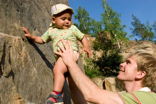 Photo of daddy teaching his son rock-climbing