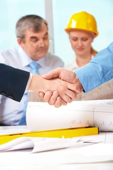 Image of customer and architect handshaking after making an agreement
