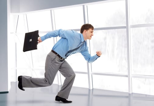 A running businessman with briefcase