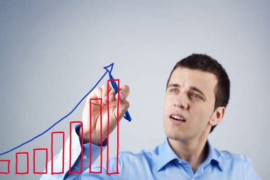 Confident businessman drawing success scheme