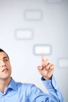 Close-up of young businessman pressing virtual button