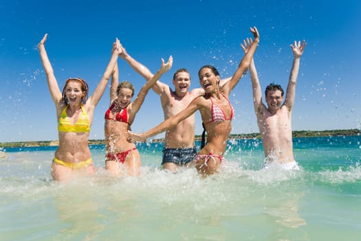 Image of happy teens playing while their vacation