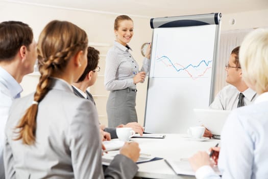 Photo of successful businesswoman presenting new project to partners