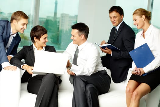 Five business people communicating in office