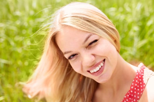 Portrait of a beautiful woman winking at you and smiling