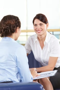 Portrait of confident businesswomen consulting in office