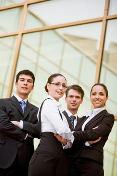 Portrait of well-dressed business partners with their arms crossed looking at camera and smiling