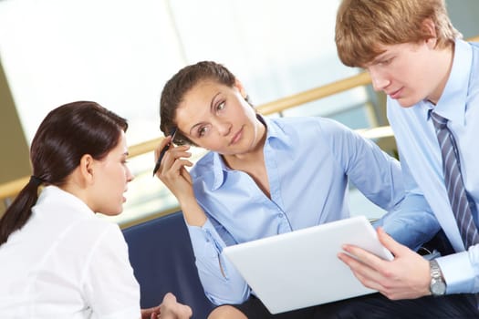 Portrait of pensive businesswoman looking at female sharing her idea
