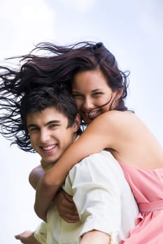 Photo of happy girl embracing handsome guy against blue sky at summer