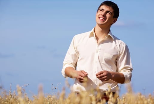 Image of happy man on background of blue sky outdoors