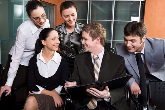 Group of smiling people signing the contract