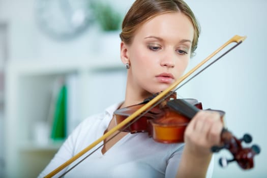 Portrait of a young female playing the violin
