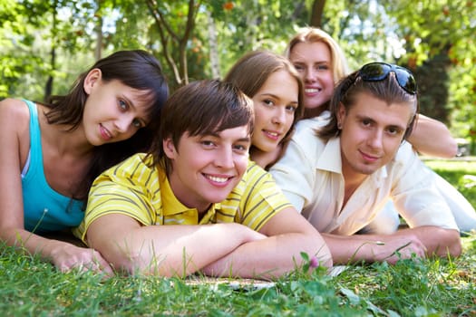 Photo of several happy friends spending time together outdoors