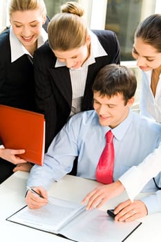 Four business people looking at the document with smiles