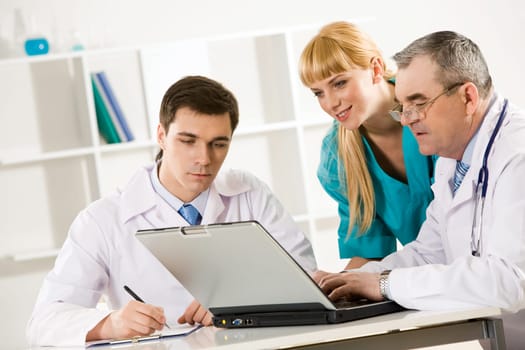 Photo of three colleagues working at new medical project and thinking about it