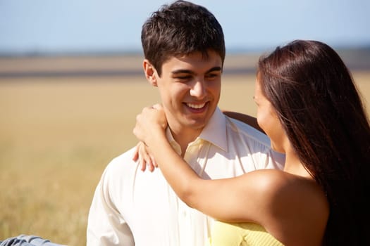 Portrait of man holding beautiful girlfriend while relaxing outside