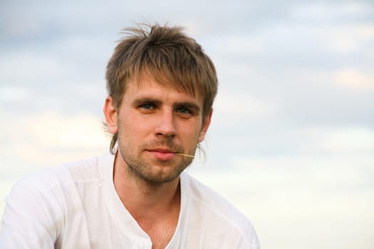 Portrait of attractive man in white t-shirt at summer
