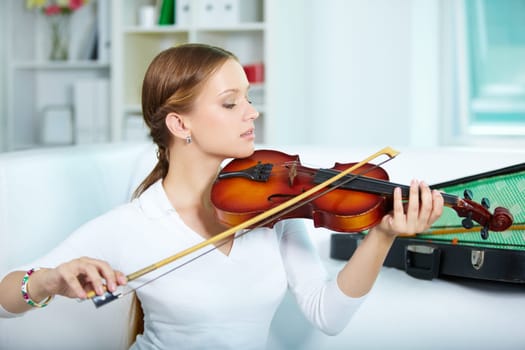 Portrait of a young female playing the violin