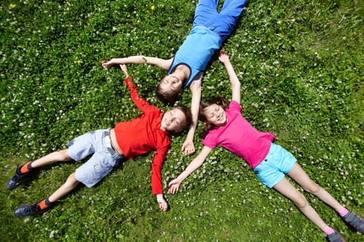 Three children having break on grass