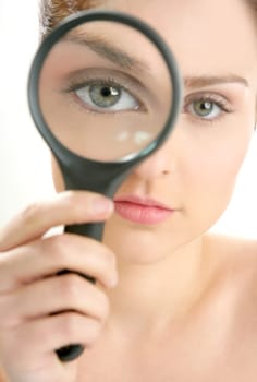 Portrait of woman with magnifier lens on eye isolated on white