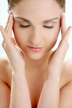 Portrait of young beautiful woman with clean skin at studio