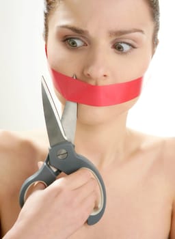 Beautiful woman with red tape on mouth portrait isolated on white