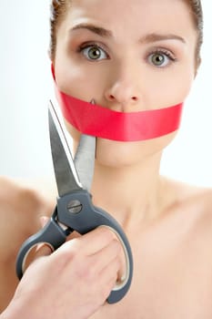 Beautiful woman with red tape on mouth portrait isolated on white