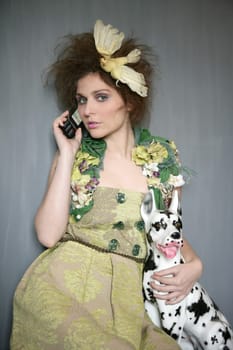 Modern fashion original woman talking phone with dalmatian dog