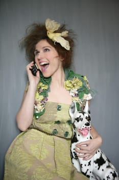 Modern fashion original woman talking phone with dalmatian dog