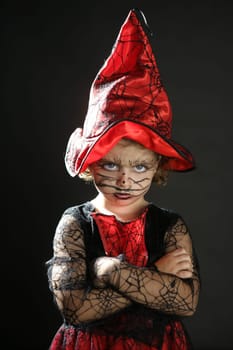 Toddler beautiful witch girl wearing halloween costume and make up